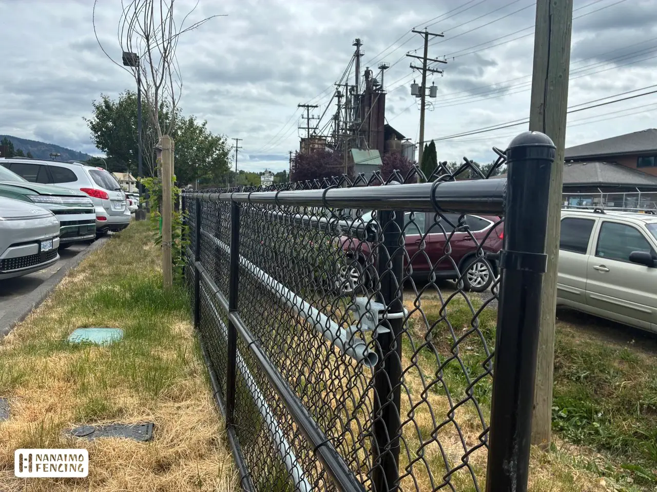 Black Vinyl-Coated Chain Link Fence & Rolling Gate Installation in Nanaimo
